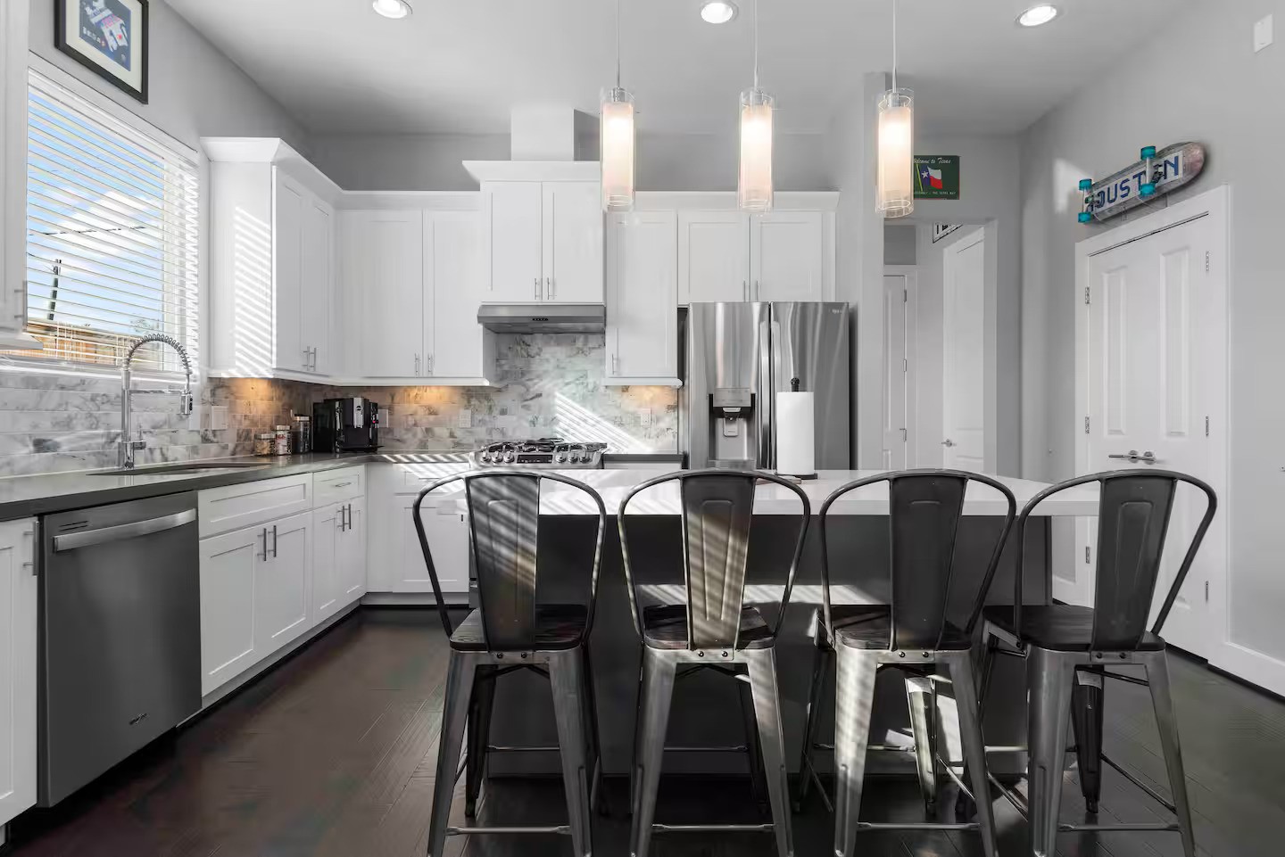 4202 Gillespie Street, Unit A Houston, TX 77020 - Photo 11 of 20 a kitchen with a table chairs refrigerator and cabinets
