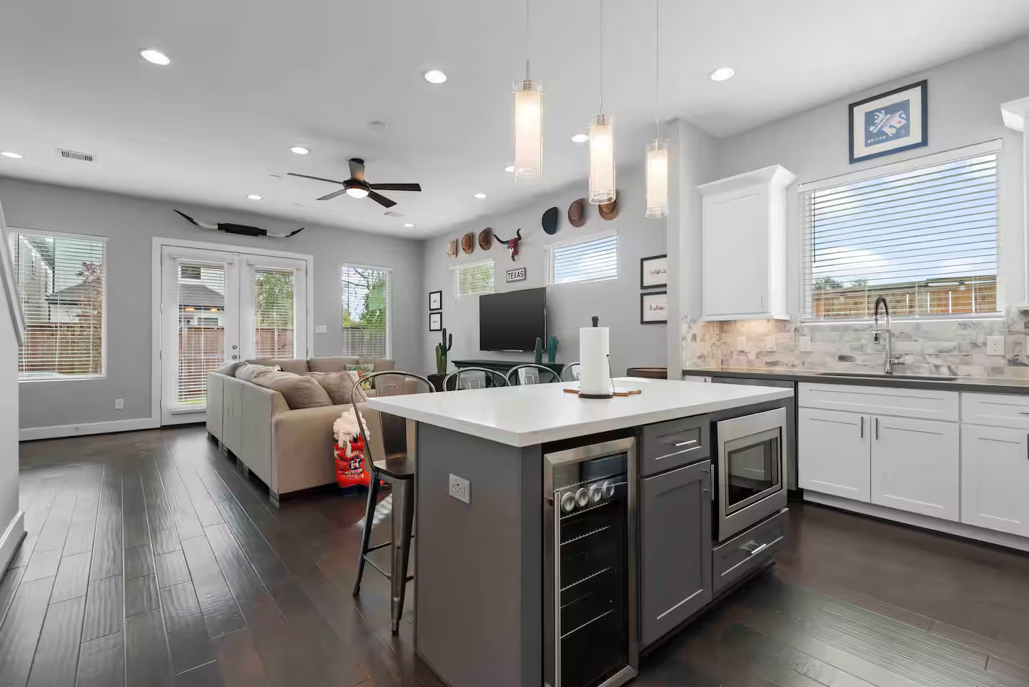 4202 Gillespie Street, Unit A Houston, TX 77020 - Photo 10 of 20 a kitchen with kitchen island a sink and a stove top oven with wooden floor