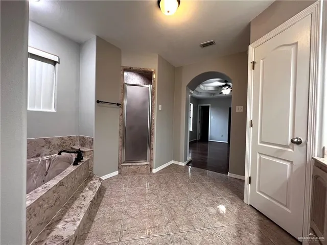 an empty room with windows and wooden floor