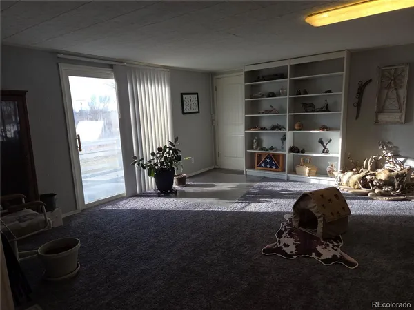 a view of a dining room with furniture and window
