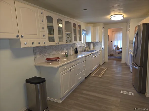 a kitchen with a sink and refrigerator