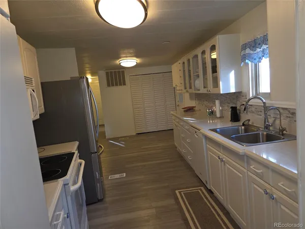 a kitchen with granite countertop a sink and cabinets