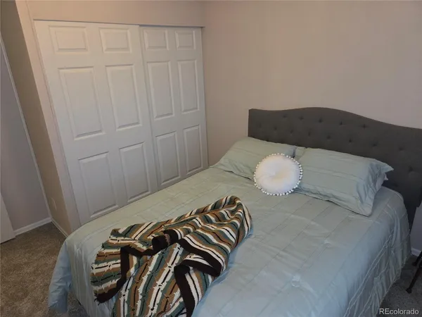 a bed sitting in a bedroom next to a window