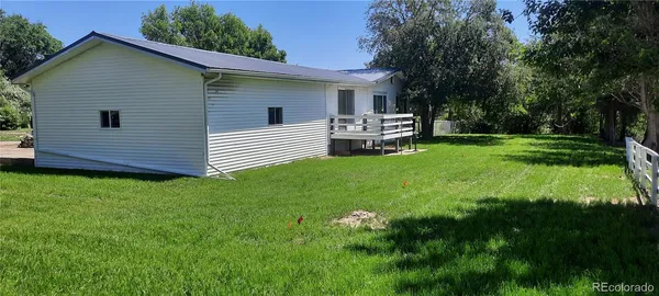 a view of a porch with chairs and a table