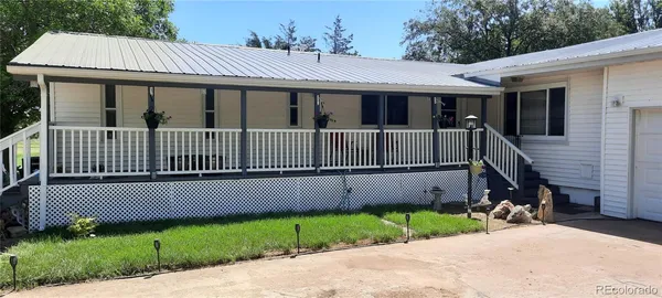a view of a small house with wooden fence