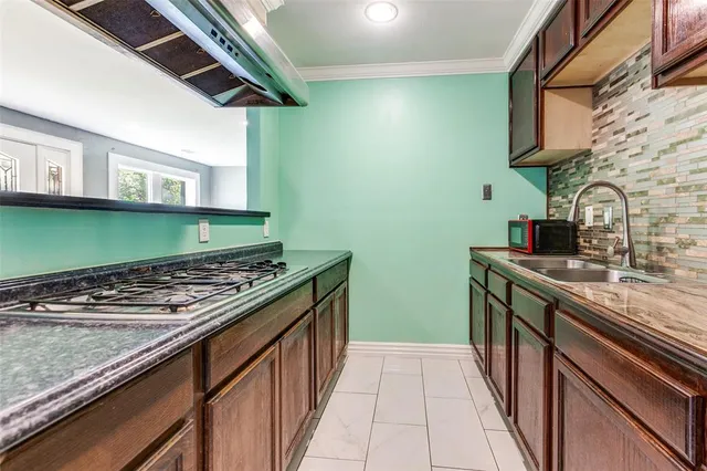 a kitchen with stainless steel appliances granite countertop a stove and a sink
