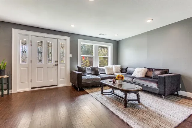 a living room with furniture and wooden floor