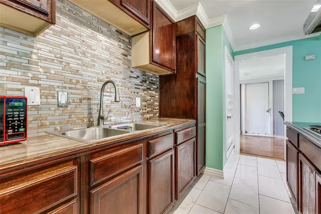 a kitchen with stainless steel appliances a sink and cabinets