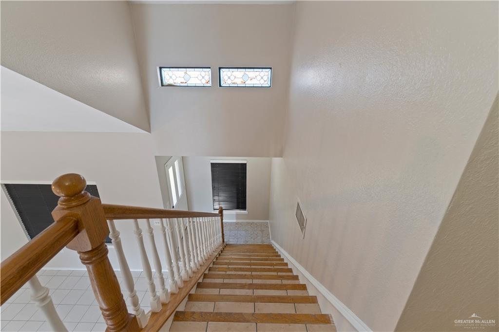 7412 North 19th Street McAllen, TX 78504 - Photo 14 of 22 a view of a hallway with wooden floor and staircase