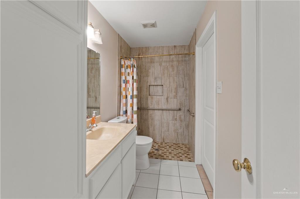 7412 North 19th Street McAllen, TX 78504 - Photo 16 of 22 a bathroom with a sink a toilet and shower
