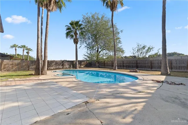 a view of a swimming pool with a yard