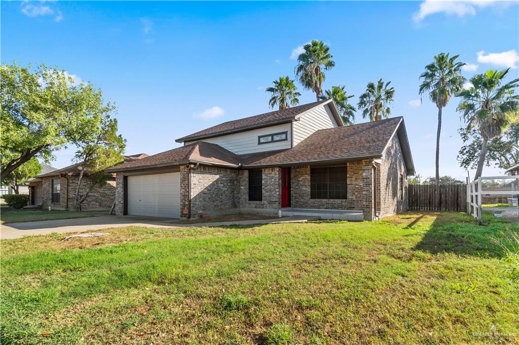 7412 North 19th Street McAllen, TX 78504 - Photo 2 of 22 a front view of a house with a yard and garage
