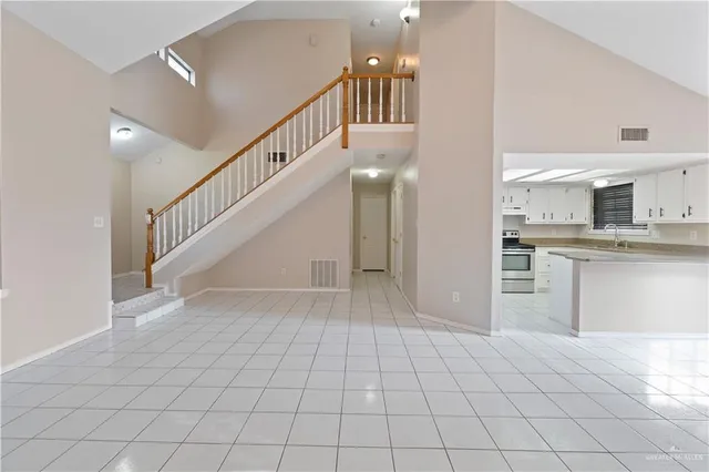 a view of an entryway with wooden floor and a kitchen view