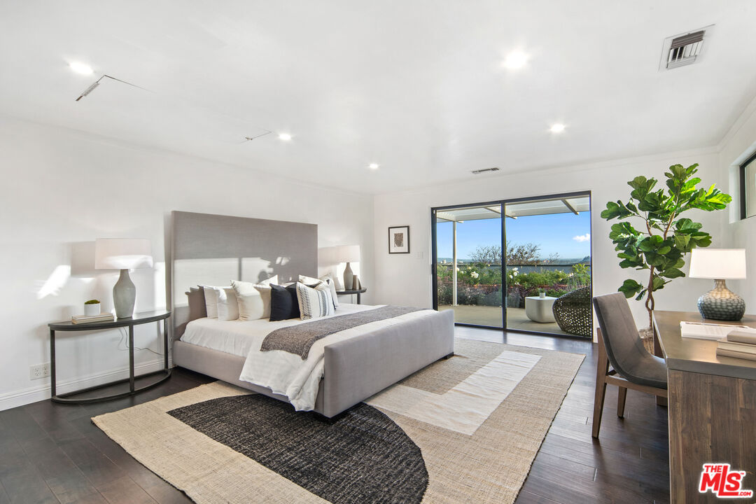 1820 Braemar Road Pasadena, CA 91103 - Photo 41 of 75 a bedroom with a large bed and a potted plant