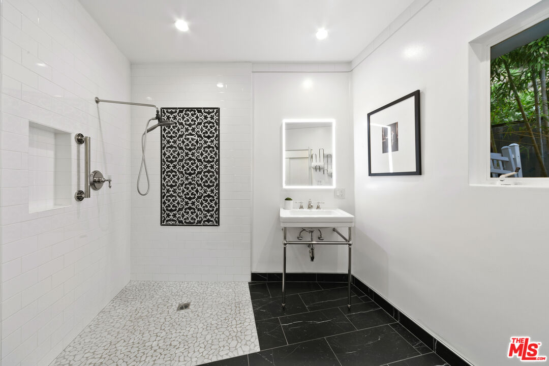 1820 Braemar Road Pasadena, CA 91103 - Photo 51 of 75 a bathroom with a sink a mirror and a shower