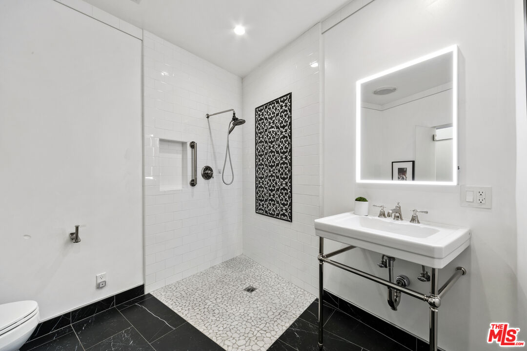 1820 Braemar Road Pasadena, CA 91103 - Photo 52 of 75 a bathroom with a sink a toilet and shower