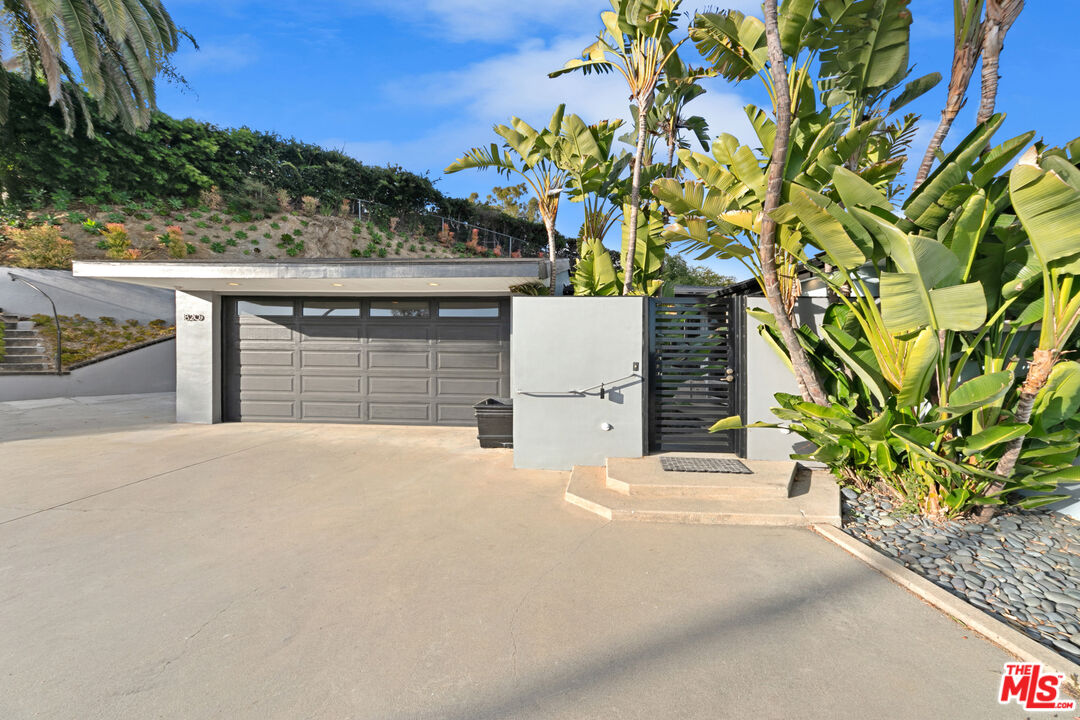 1820 Braemar Road Pasadena, CA 91103 - Photo 9 of 75 a front view of a house with a yard and garage