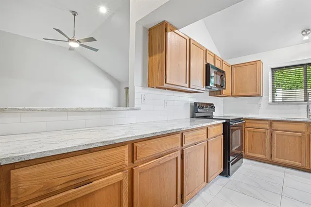 a kitchen with stainless steel appliances granite countertop a sink and cabinets
