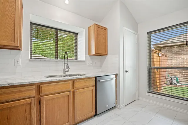 a kitchen with a sink and cabinets