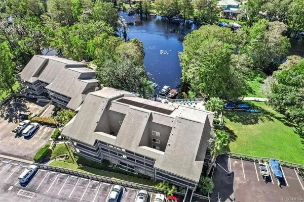 an aerial view of a house with outdoor space and lake view