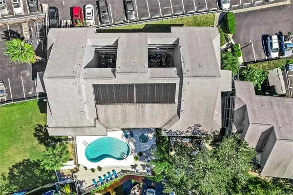 an aerial view of a house with a yard and garden
