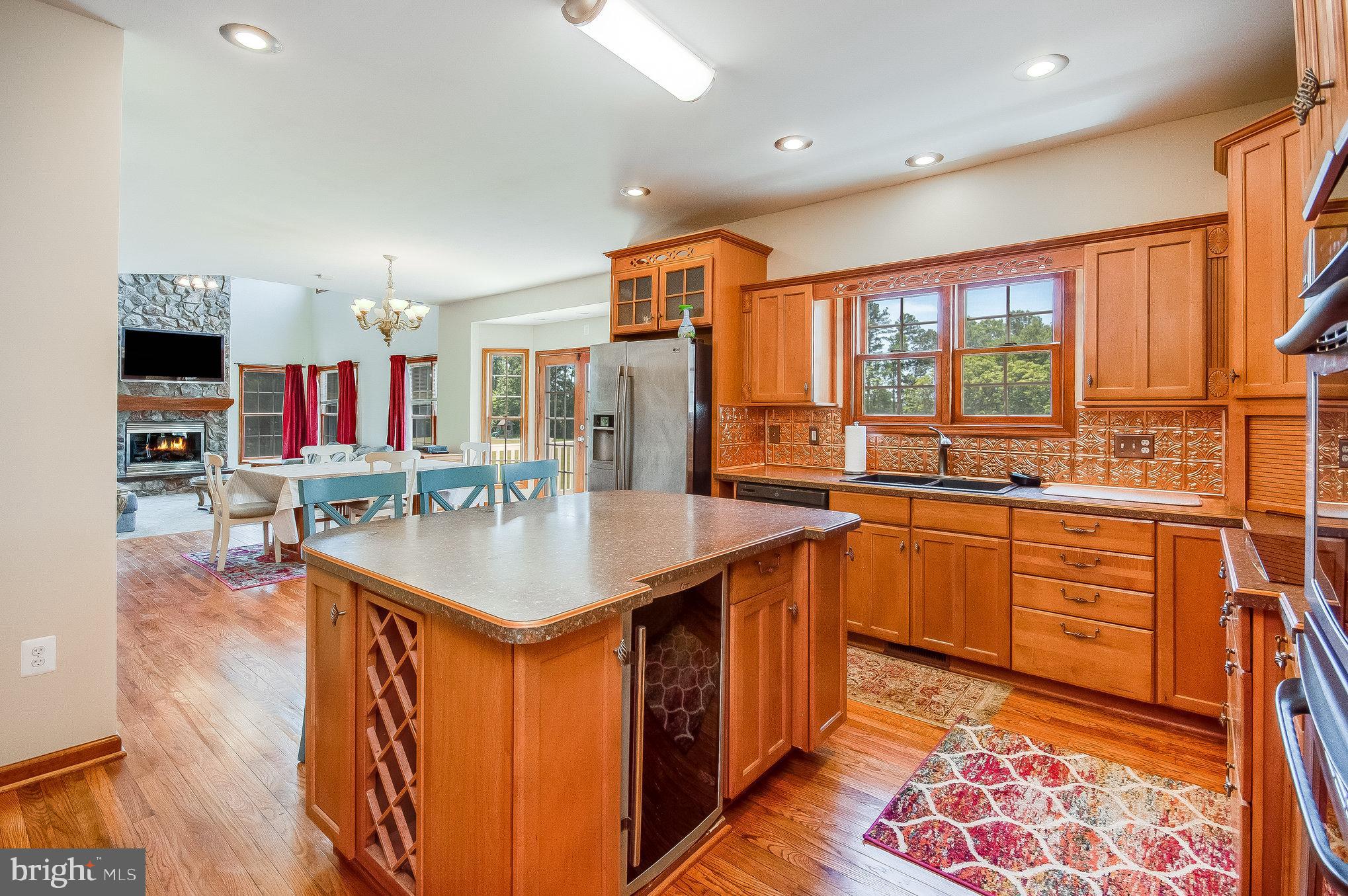 11425 Custers Trace Spotsylvania, VA 22553 - Photo 12 of 60 a kitchen with stainless steel appliances granite countertop a sink and a wooden floors