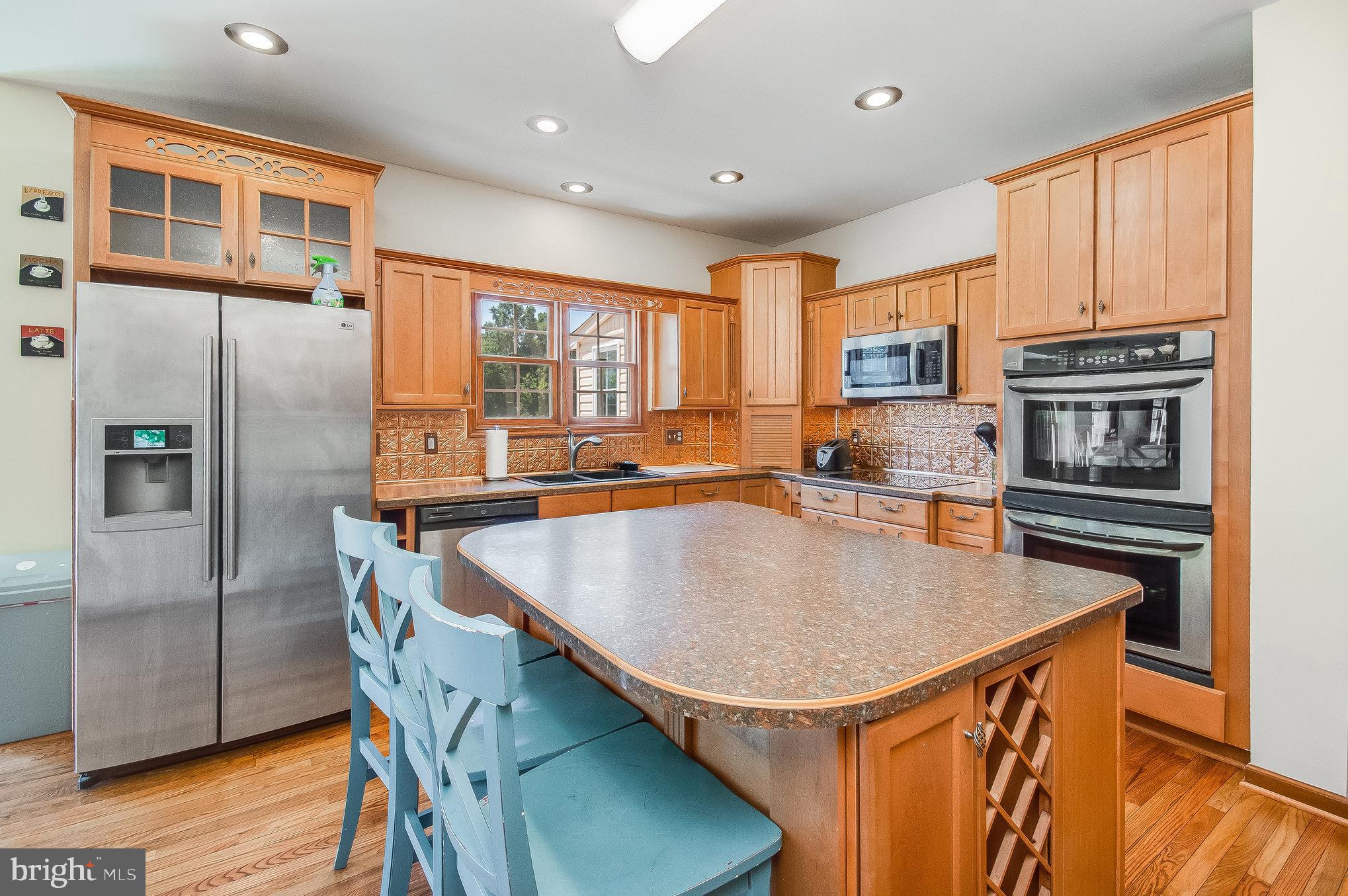 11425 Custers Trace Spotsylvania, VA 22553 - Photo 14 of 60 a kitchen with stainless steel appliances granite countertop a sink a stove and a refrigerator