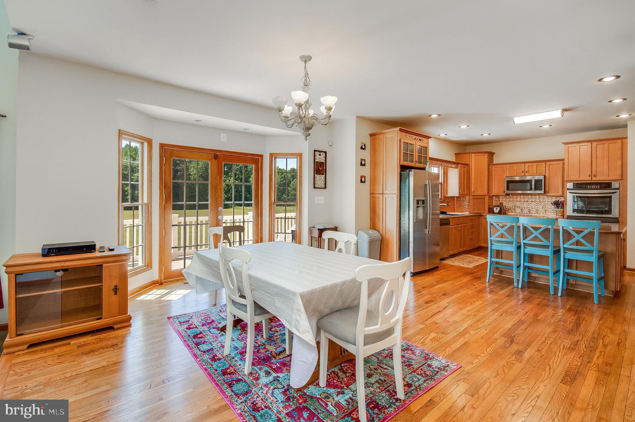11425 Custers Trace Spotsylvania, VA 22553 - Photo 15 of 60 a view of a dining room with furniture window and wooden floor