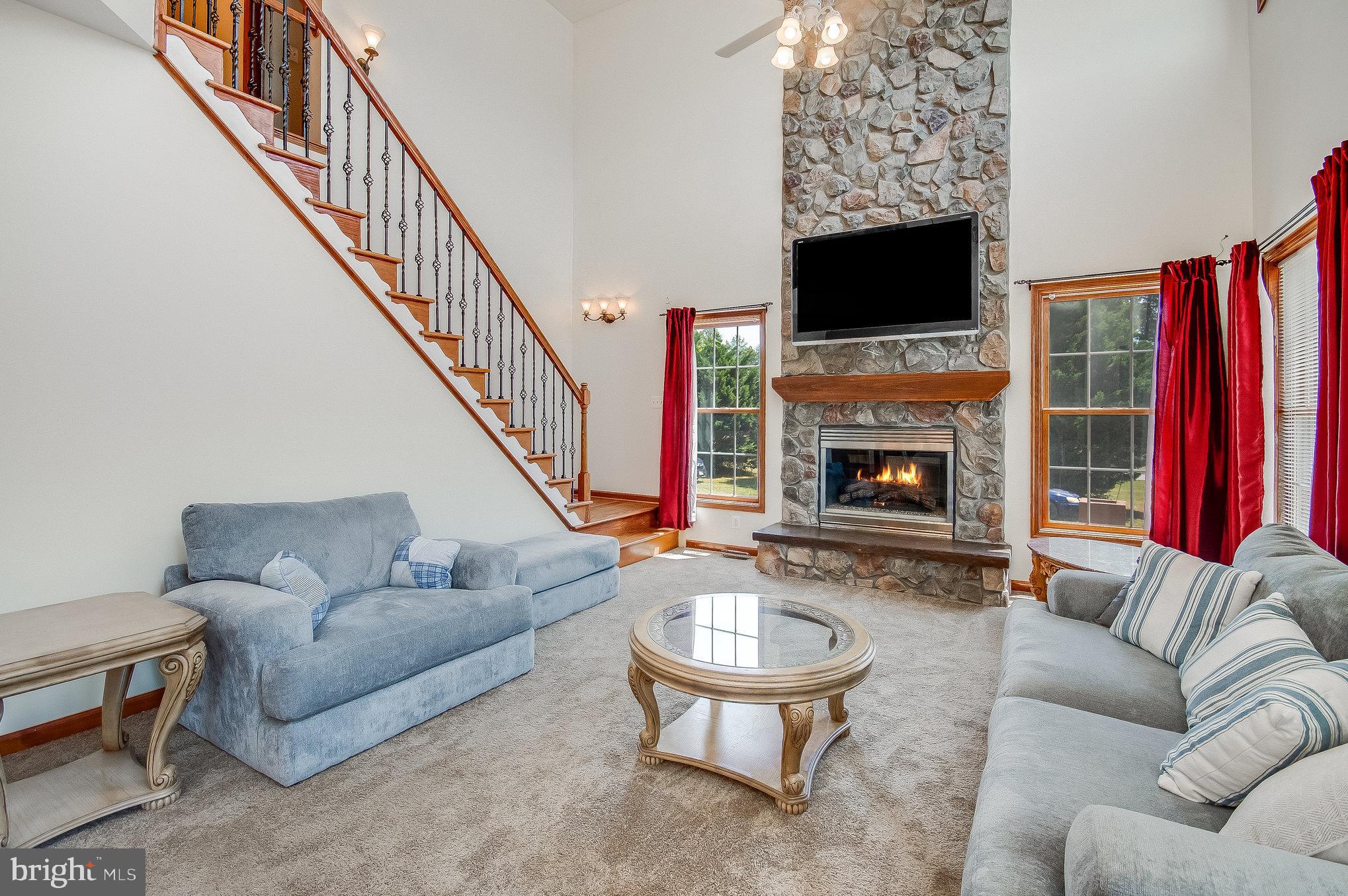 11425 Custers Trace Spotsylvania, VA 22553 - Photo 20 of 60 a living room with furniture a flat screen tv and a fireplace