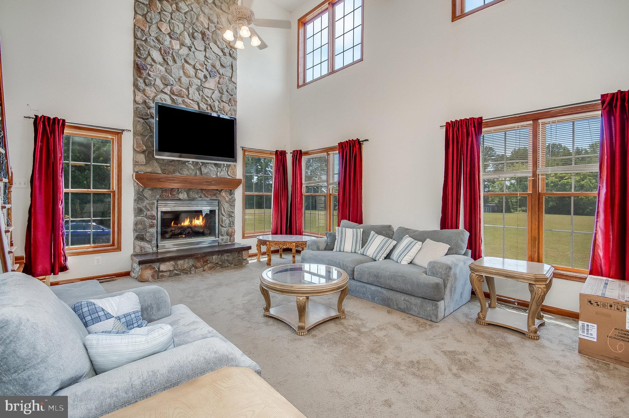 11425 Custers Trace Spotsylvania, VA 22553 - Photo 21 of 60 a living room with furniture a flat screen tv and a fireplace