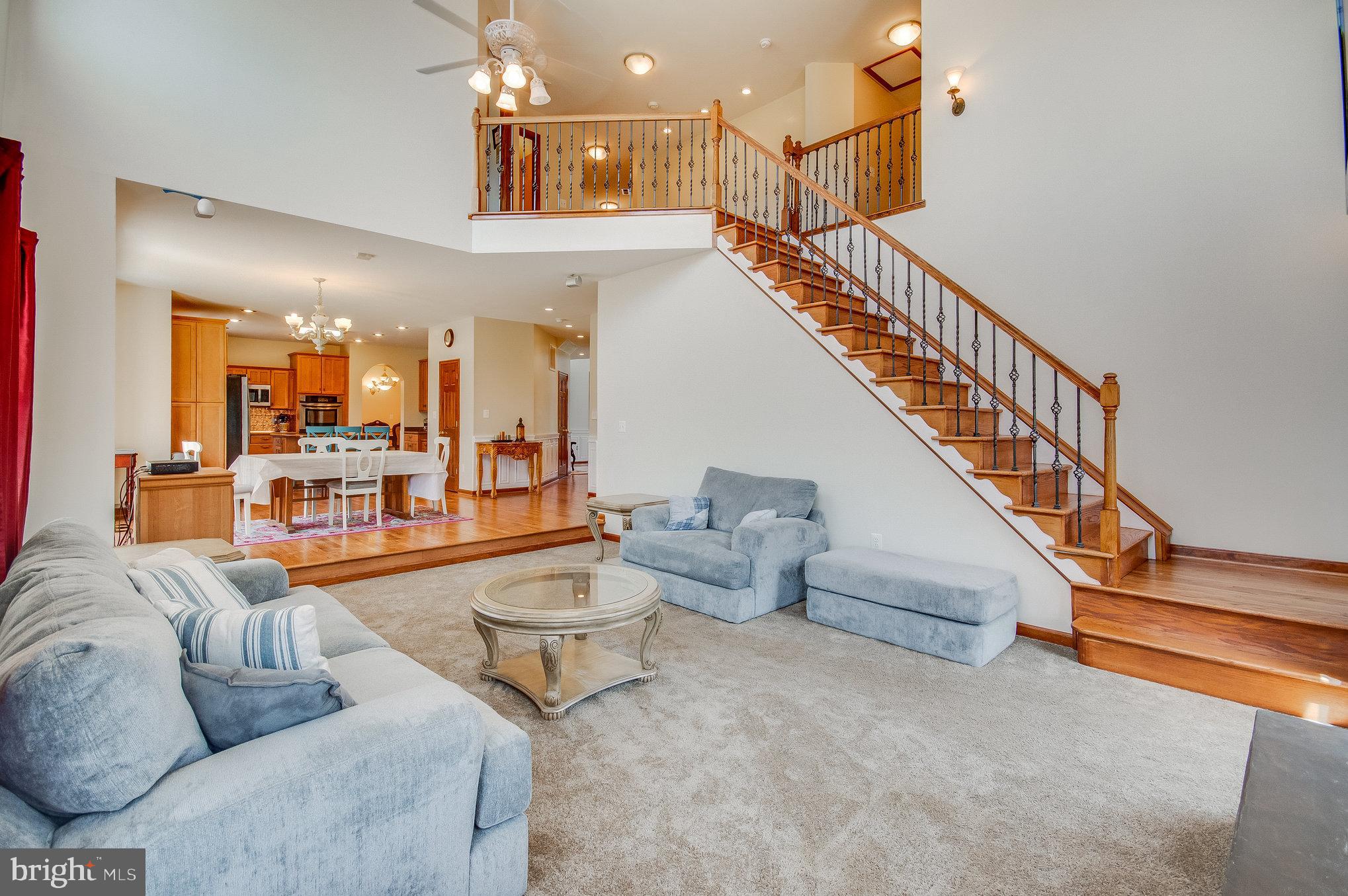 11425 Custers Trace Spotsylvania, VA 22553 - Photo 22 of 60 a living room with furniture and a chandelier