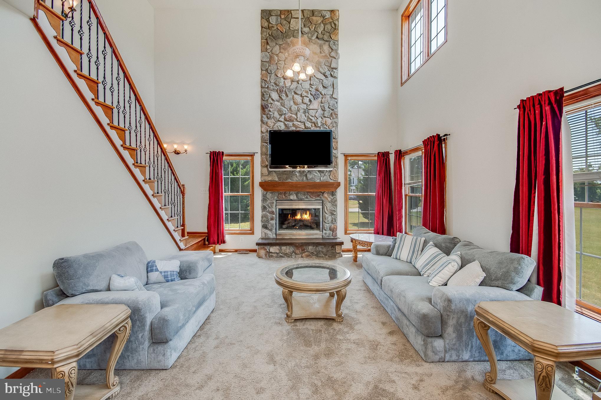 11425 Custers Trace Spotsylvania, VA 22553 - Photo 23 of 60 a living room with furniture a flat screen tv and a fireplace