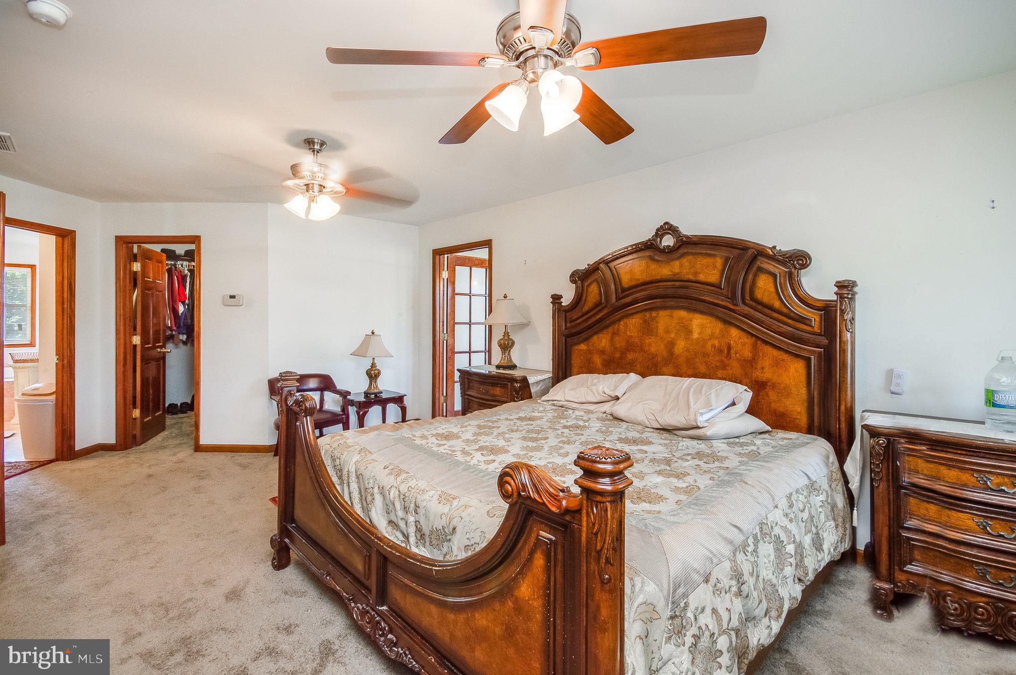 11425 Custers Trace Spotsylvania, VA 22553 - Photo 27 of 60 a bedroom with a bed a chandelier and dresser