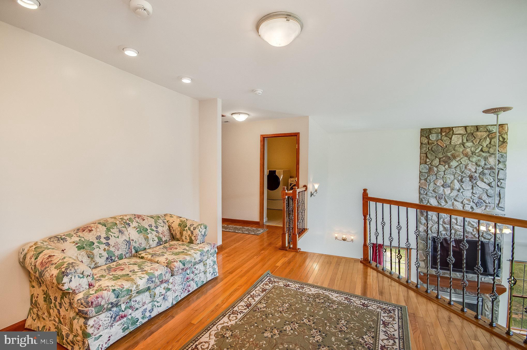 11425 Custers Trace Spotsylvania, VA 22553 - Photo 44 of 60 a living room with a bed and a couch
