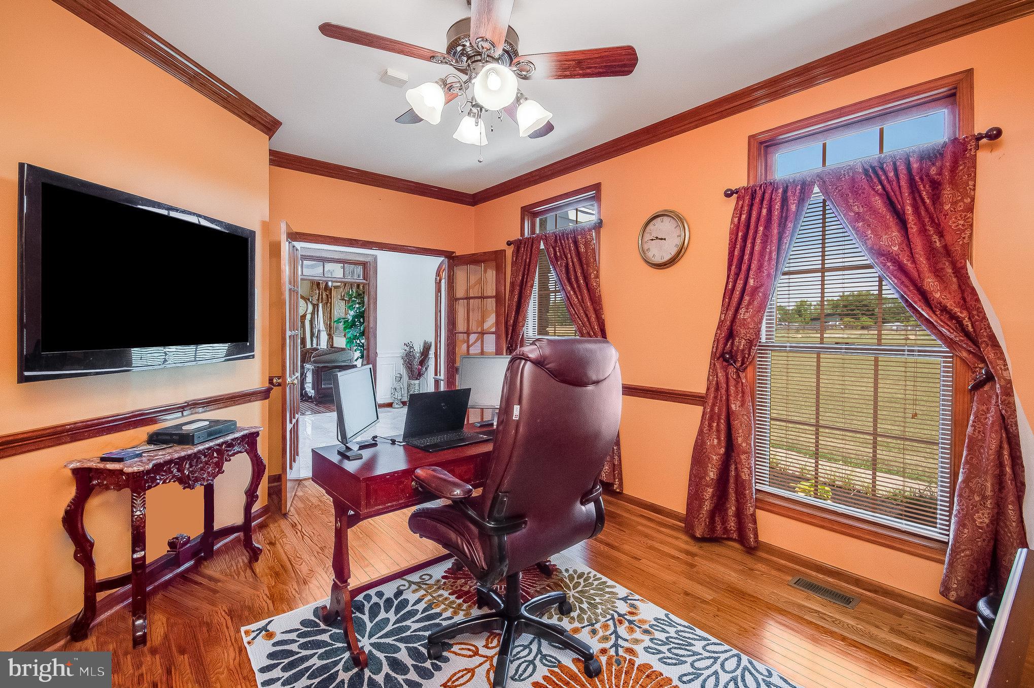 11425 Custers Trace Spotsylvania, VA 22553 - Photo 6 of 60 a living room with furniture a flat screen tv and a floor to ceiling window