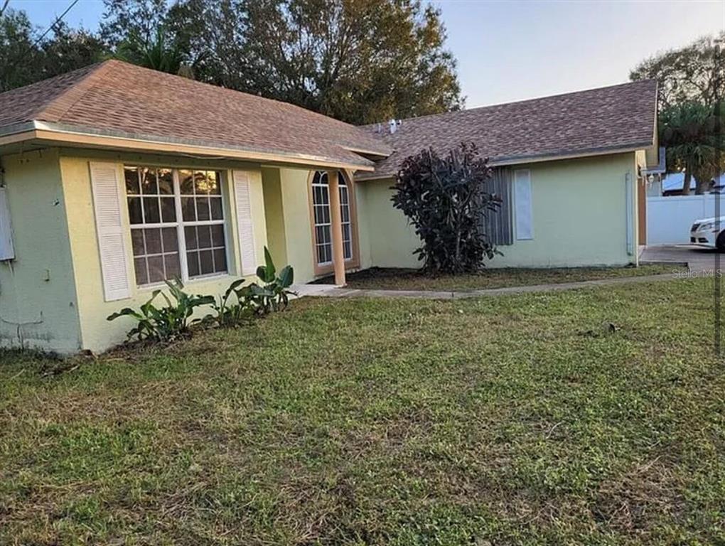 709 Southwest Aster Road Port St. Lucie, FL 34953 - Photo 2 of 6 a front view of a house with garden