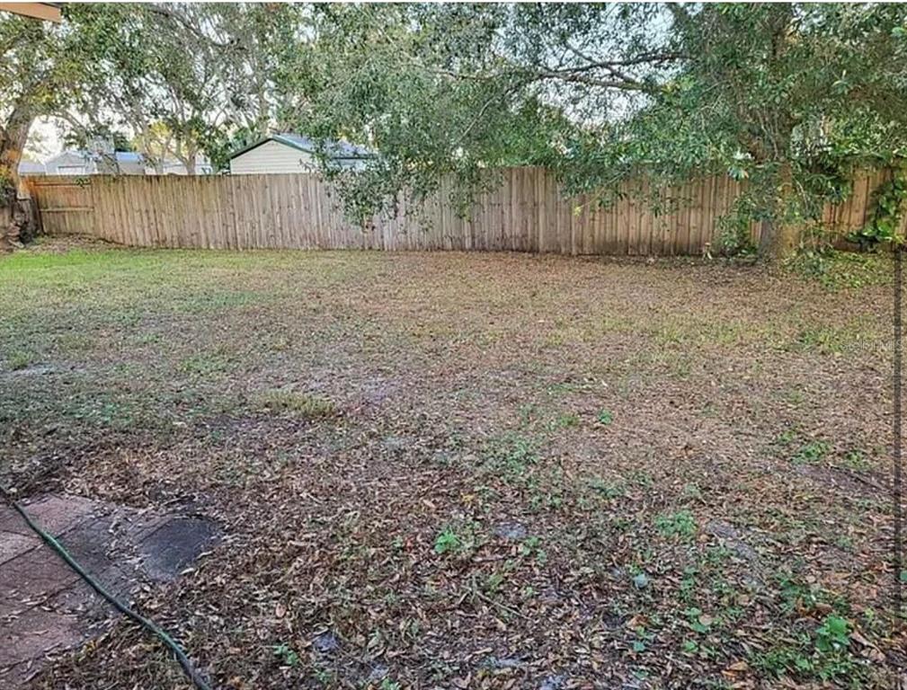 709 Southwest Aster Road Port St. Lucie, FL 34953 - Photo 3 of 6 a view of a yard with a wooden fence