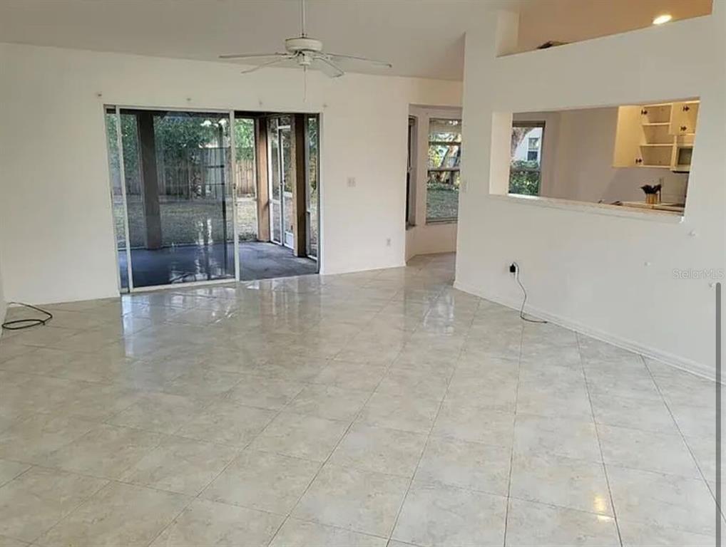 709 Southwest Aster Road Port St. Lucie, FL 34953 - Photo 6 of 6 wooden floor and window in an empty room