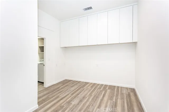 a view of a room with wooden floor