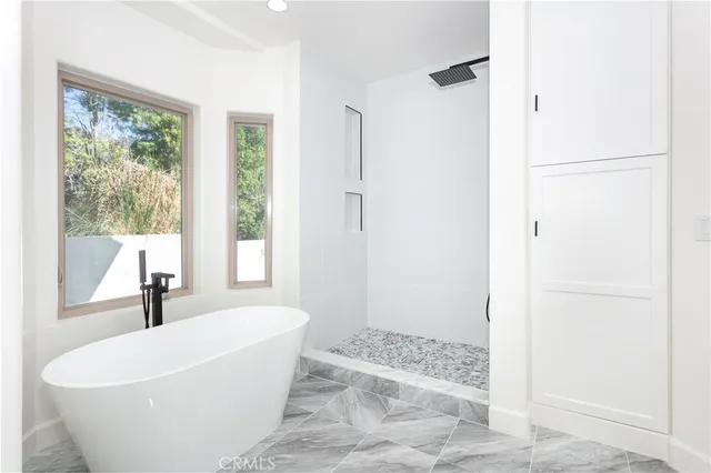 a white bath tub sitting next to a window