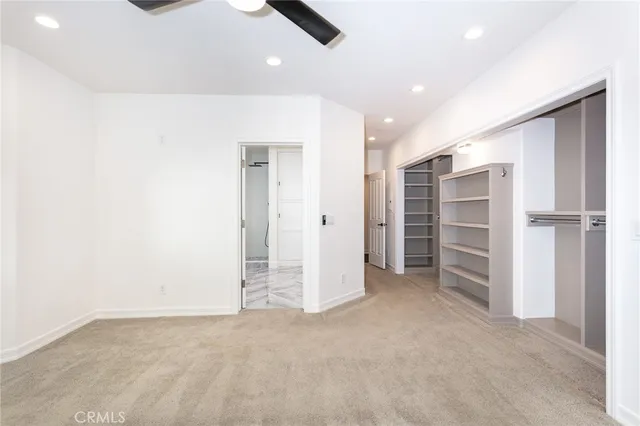 an empty room with a closet and storage