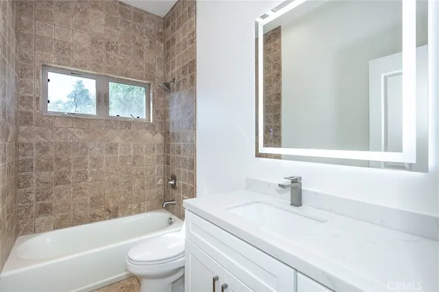 a bathroom with a sink a toilet and a bathtub