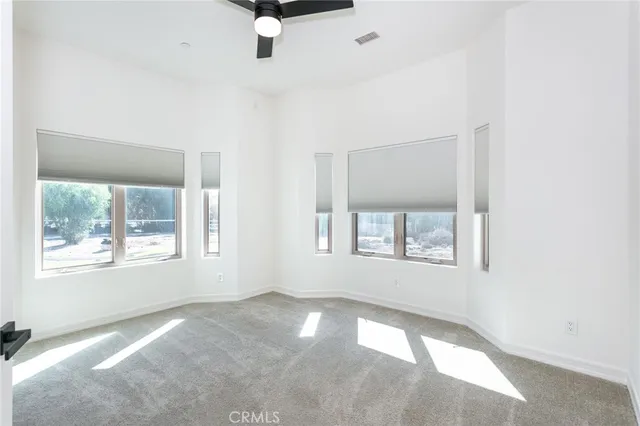 an empty room with windows and closet