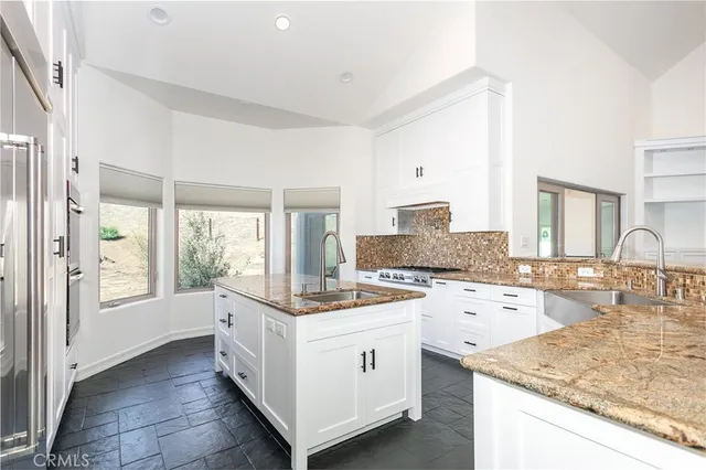 a kitchen with a stove a sink and a refrigerator
