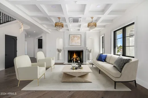 a spacious bedroom with a large bed and a chandelier