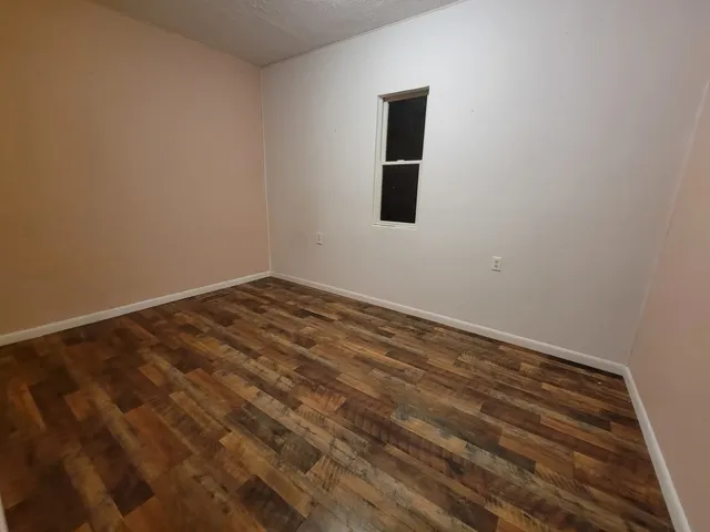 a view of a small space with wooden floor