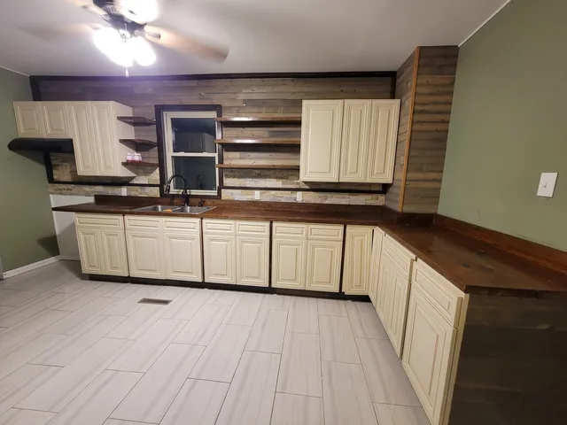 a kitchen with stainless steel appliances granite countertop a sink and cabinets