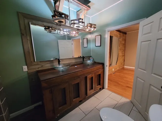 a view of bathroom with a sink and mirror