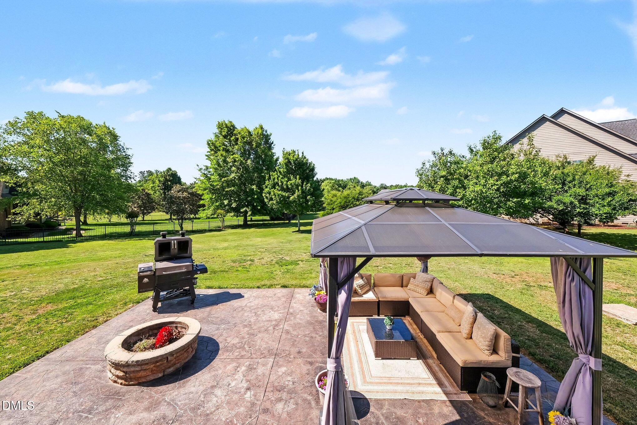 4000 Banks Stone Drive Raleigh, NC 27603 - Photo 42 of 60 a backyard of a house with table and chairs