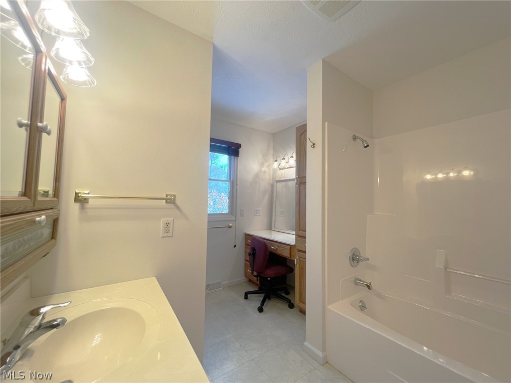 5203 Ridgeland Street Lorain, OH 44055 - Photo 15 of 39 Bathroom with vanity, tile flooring, tub / shower combination, and a textured ceiling